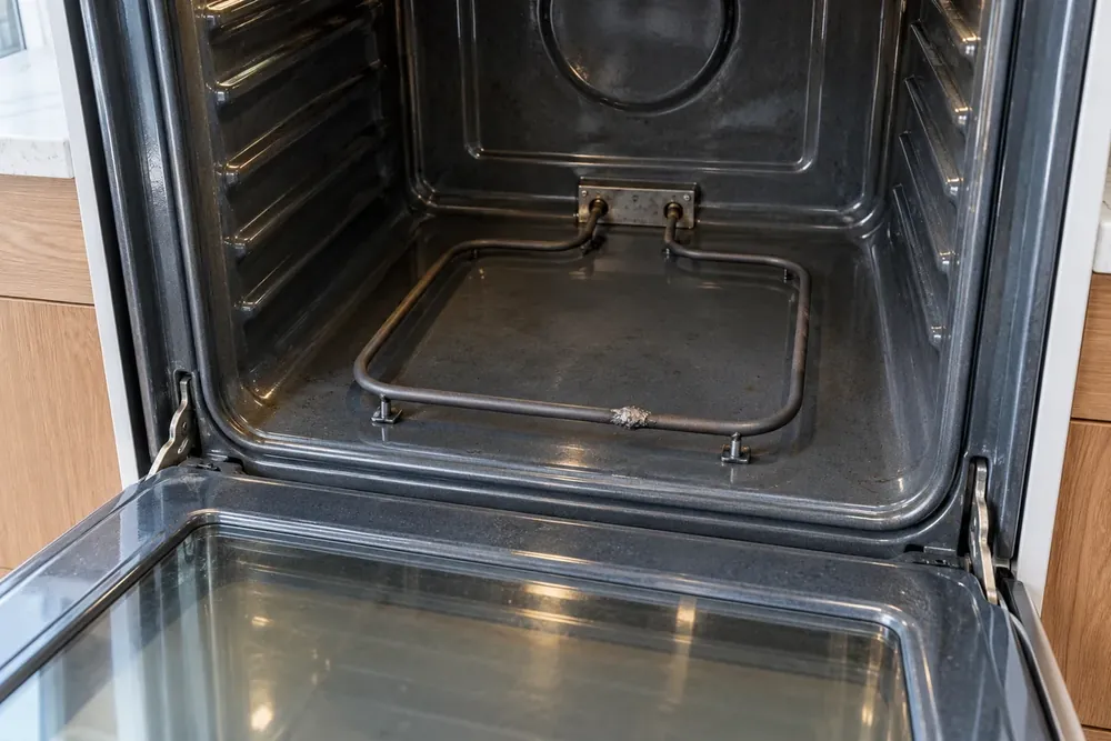 Blistered spot on an electric oven bake element inside the cavity with the door open