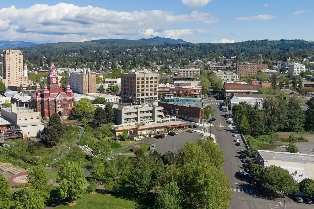 Aerial view of downtown Bellingham, Washington, with the old city hall, trees and wooded hills